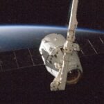 A satellite orbiting Earth with a view of the planet from space.