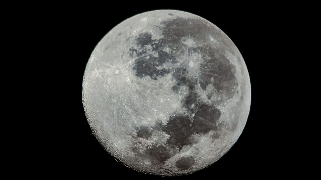 High-resolution close-up of the full moon with visible craters and texture.