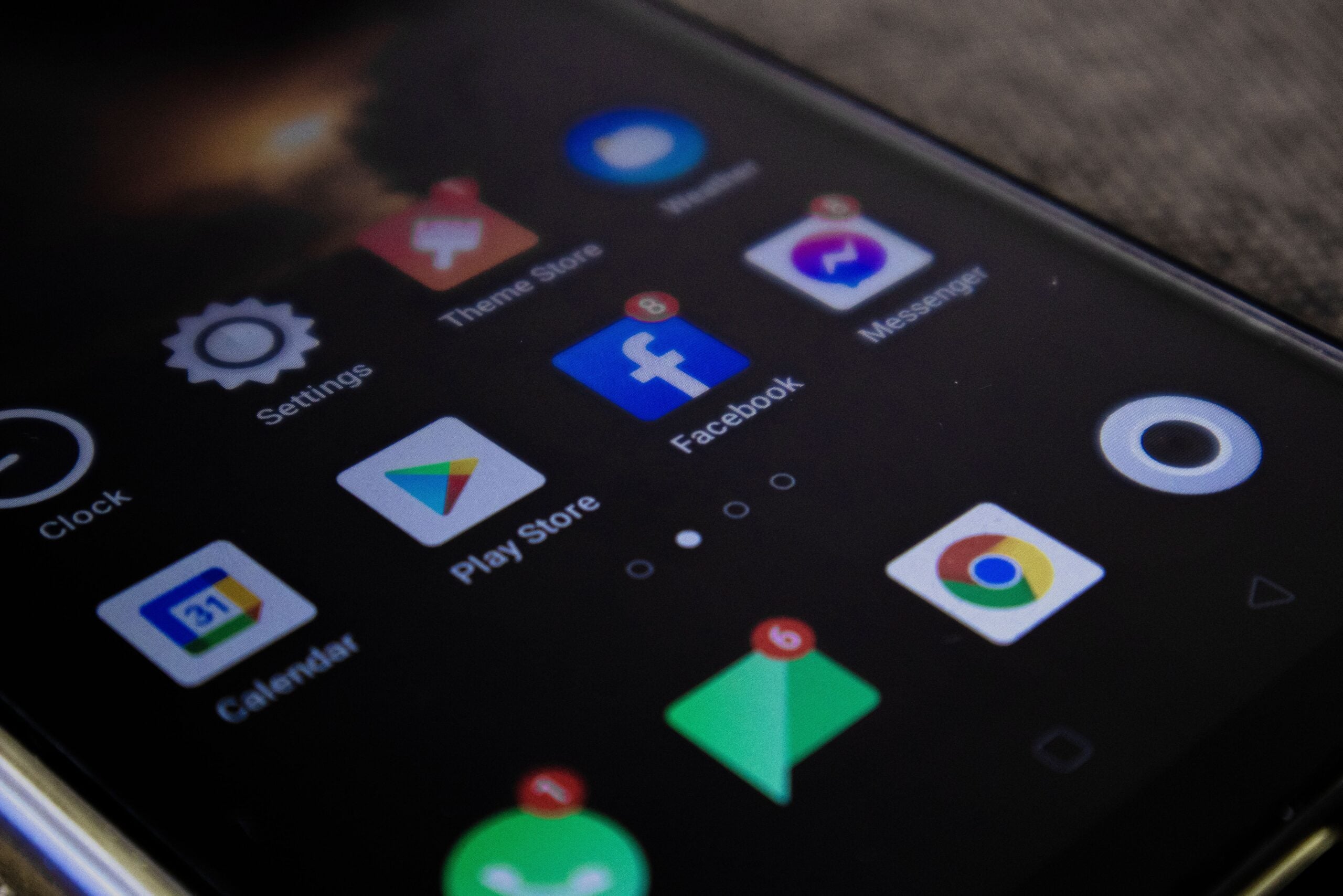 Detailed view of a smartphone screen with popular app icons including Facebook and Messenger.