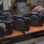 A collection of Sony digital cameras showcased in a store display case.
