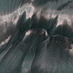 Abstract aerial view of dynamic sand patterns on Guaratuba Beach, Brazil.