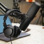Close-up of a podcast studio setup featuring a microphone and headphones.