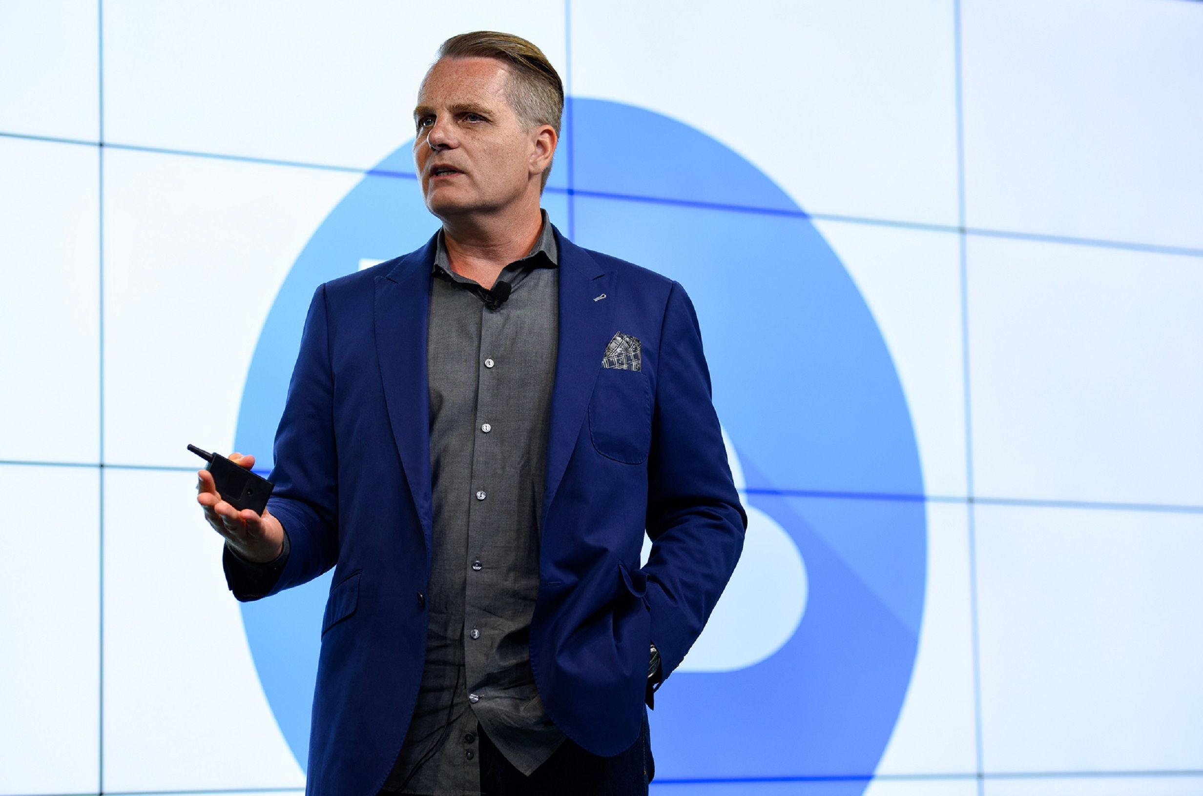 Confident businessman presenting with a microphone in New York office.