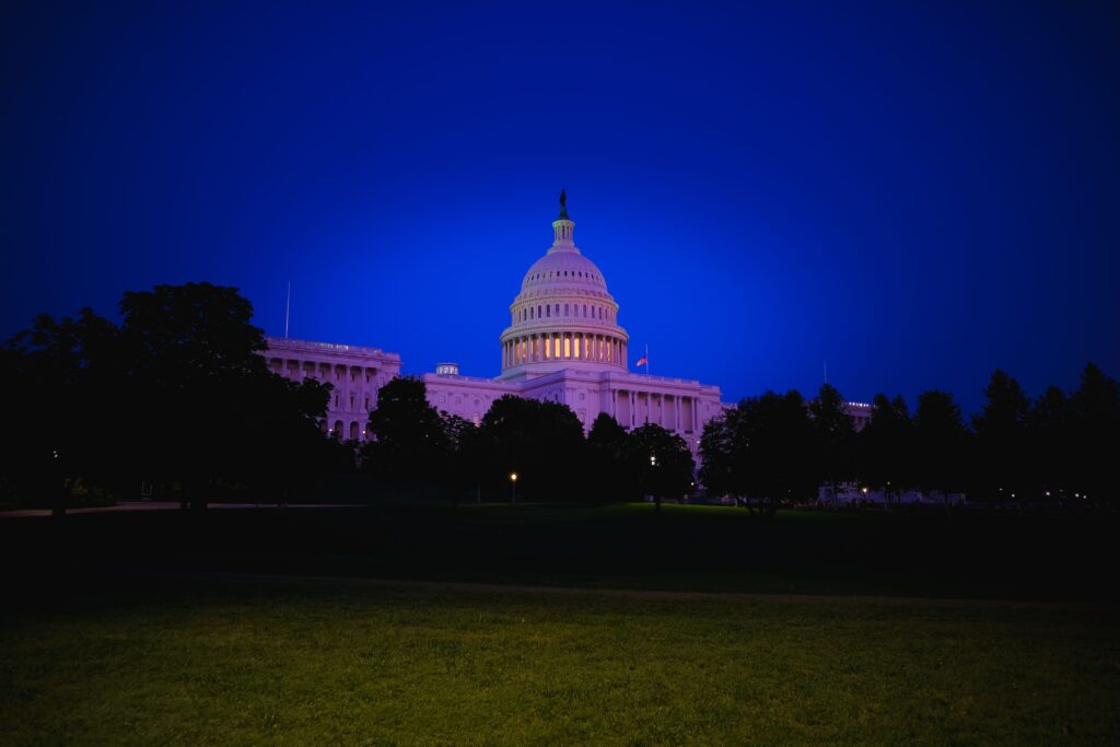 A stunning view of the US Capitol Building illuminated at twilight, showcasing its iconic dome and neoclassical architecture.